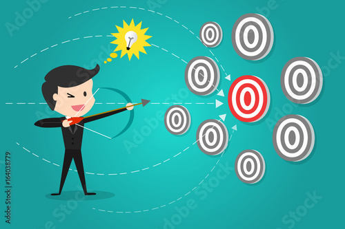 successful businessman aiming target with bow and arrow/Can decide which target to shoot at.