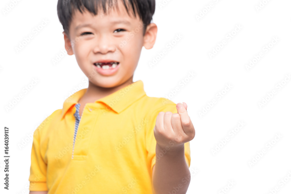 Little asian boy showing his lost milk-tooth in his hand - closeup Little asian boy showing his lost milk-tooth in his hand - closeup