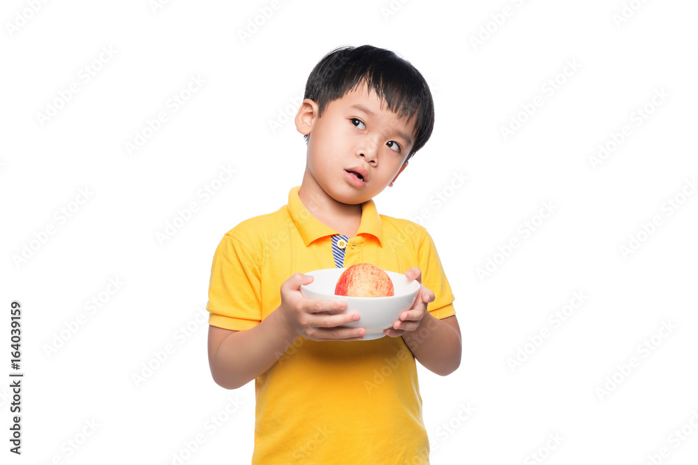 Happy Asian boy holding red apple in bowl. Happy Asian boy holding red apple in bowl.