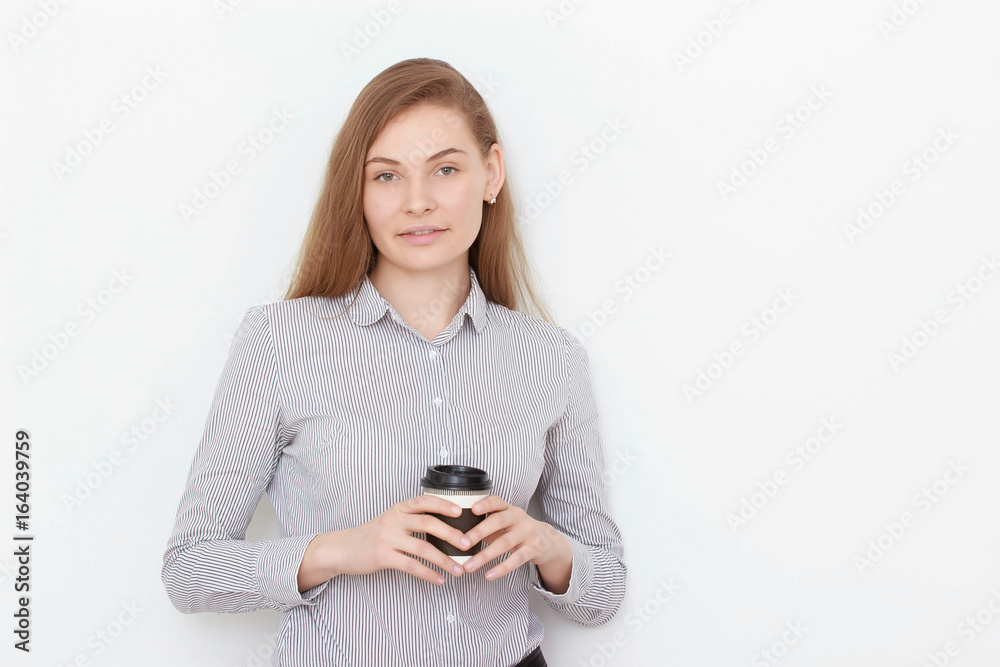 Enjoying fresh coffee on the Go. Portrait of beautiful young woman holding coffee cup Enjoying fresh coffee on the Go. Portrait of beautiful young woman holding coffee cup