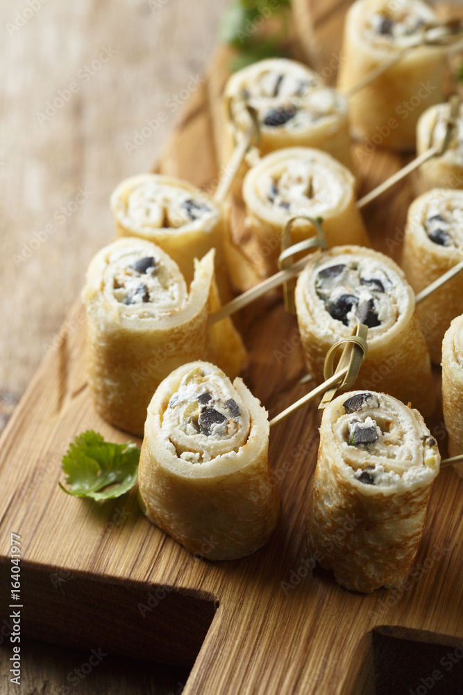 Fototapeta premium Pancakes appetizer with cream cheese and olives