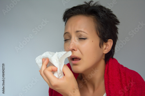 Sneezing young woman