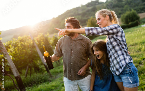 Wine grower and people in vineyard