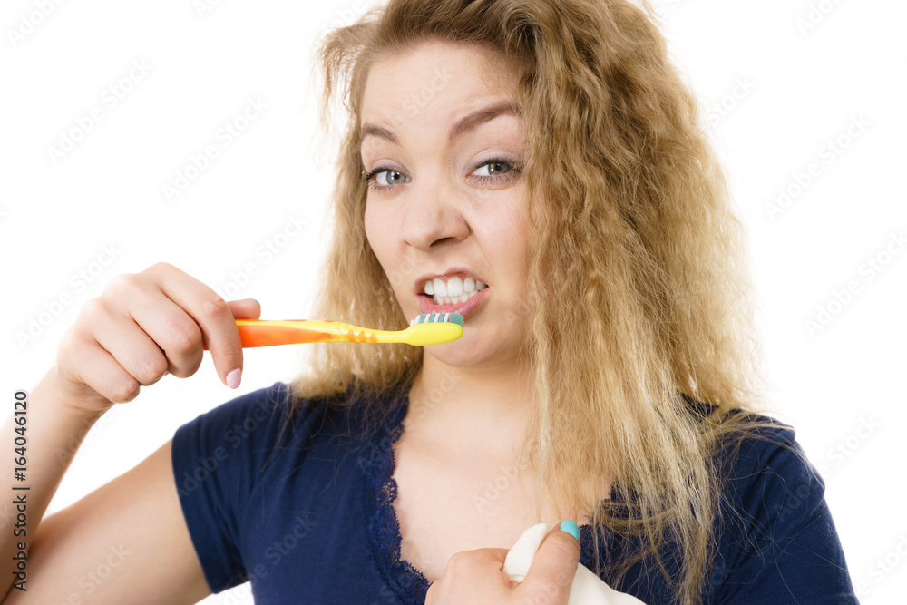 Grumpy tired woman brushing teeth, isolated Grumpy tired woman brushing teeth, isolated
