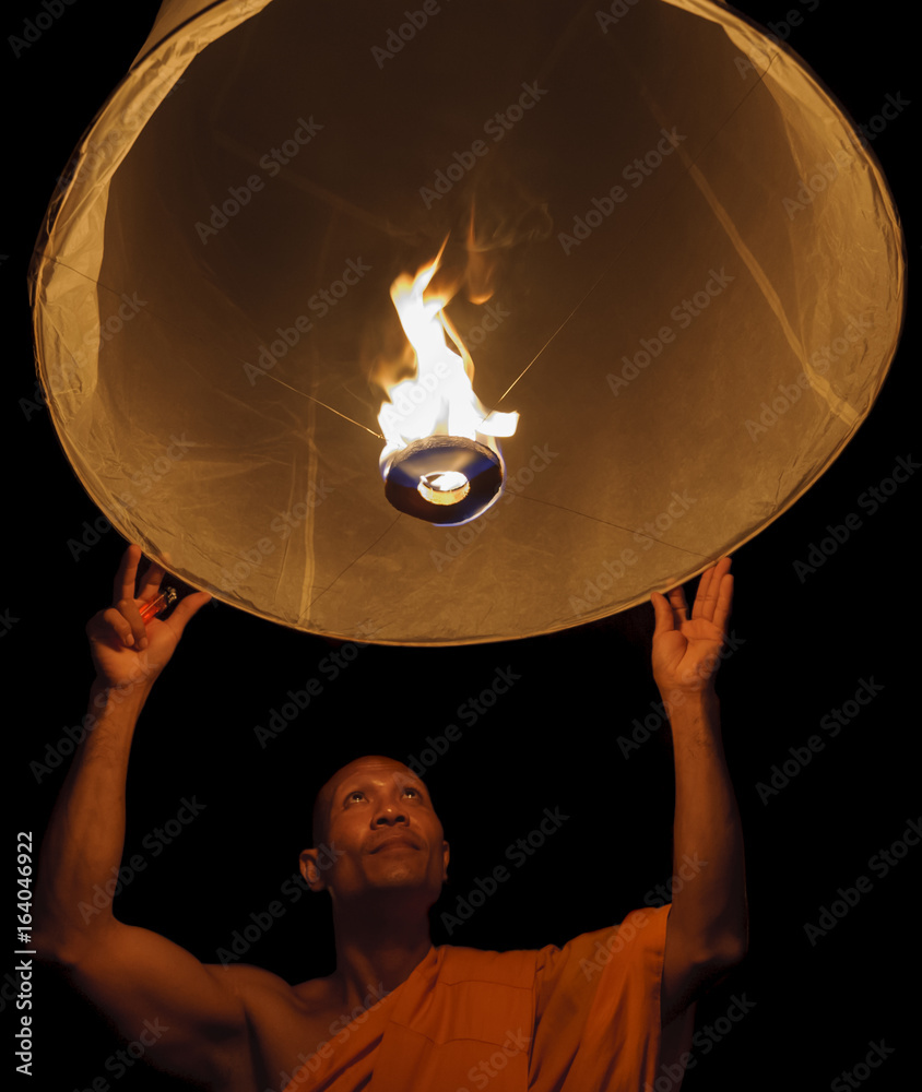 Thailand, Chiang Mai, Buddhist monk lighting lantern Stock Photo | Adobe  Stock