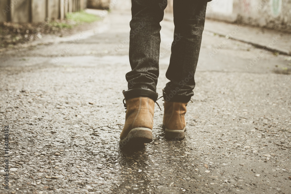 Man standing on road. Young man standing on the street. Only legs. Man standing on road. Young man standing on the street. Only legs.