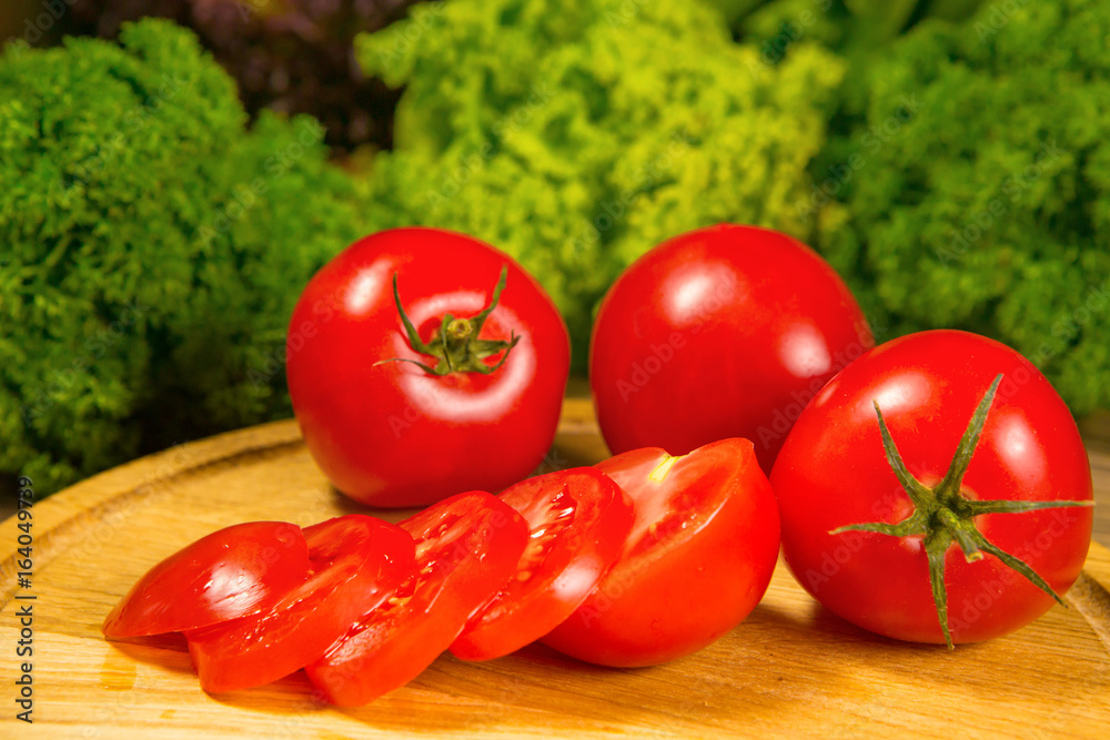 Fresh tomatoes on a wooden background. Delicious vegetarian food Fresh tomatoes on a wooden background. Delicious vegetarian food