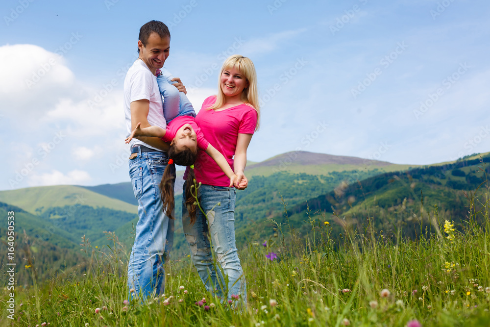 Attractive family having fun in a summer on mountain Attractive family having fun in a summer on mountain