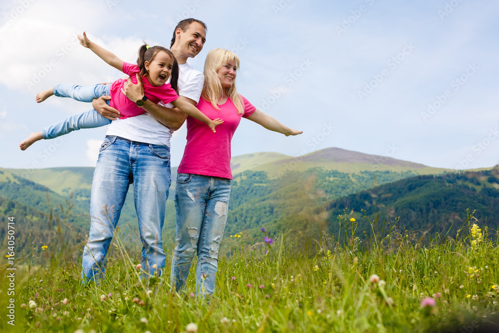 Attractive family having fun in a summer on mountain