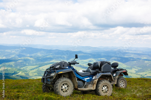 Motorsport in the mountains. Two ATVs on top of a mountain