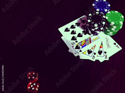 Black colours of poker game concept.  Plot with bones, chips and cards photo