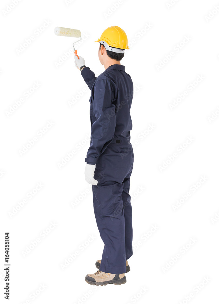 Worker in a uniform using a paint roller is painting invisible floor