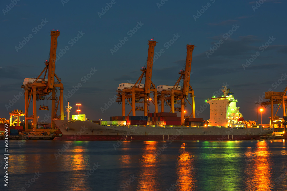 container ship in import export and business logistic.By crane , Trade Port , Shipping.Tugboat assisting cargo to harbor.Aerial view. Top view. container ship in import export and business logistic.By crane , Trade Port , Shipping.Tugboat assisting cargo to harbor.Aerial view. Top view.