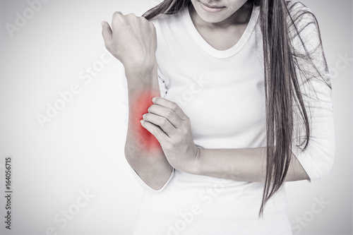 Woman scratching her elbow. photo