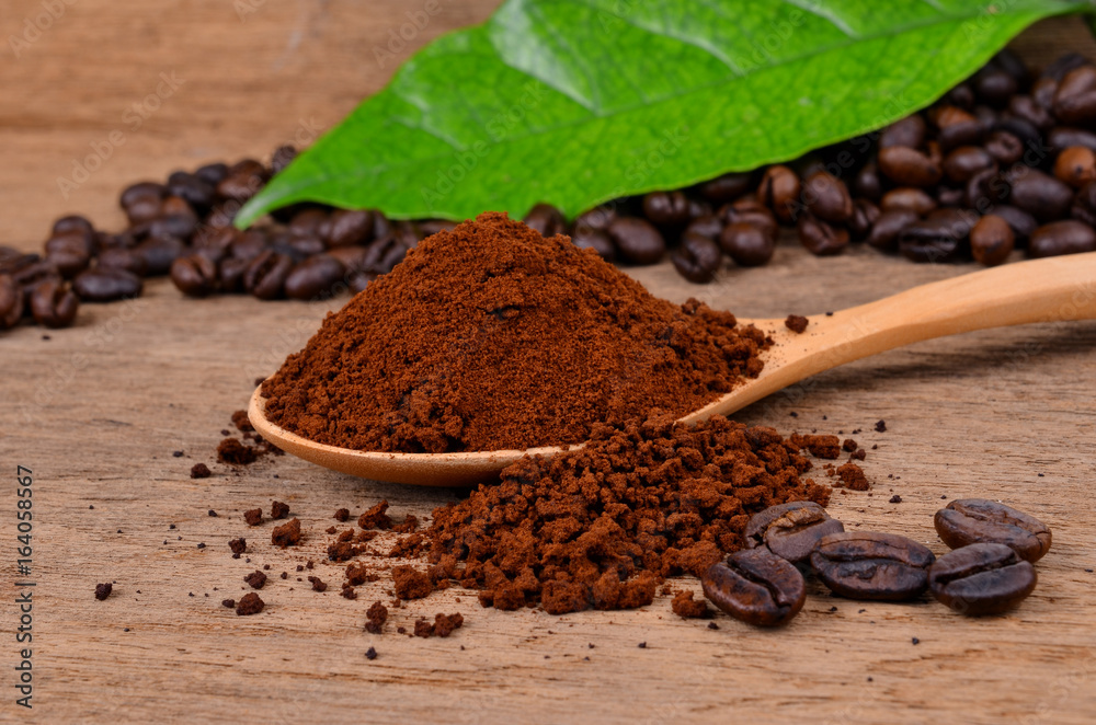 coffee beans and ground coffee on a wooden background coffee beans and ground coffee on a wooden background
