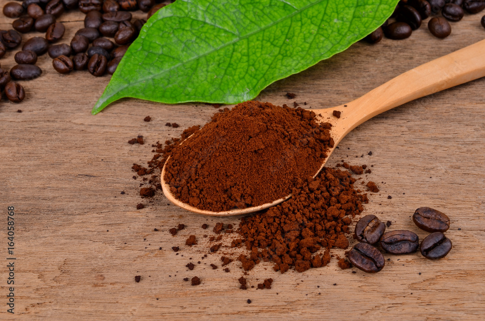 coffee beans and ground coffee on a wooden background coffee beans and ground coffee on a wooden background