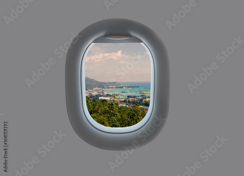 Panorama of the island of Mahe in the plane window. Tropical Seychelles in airplane window