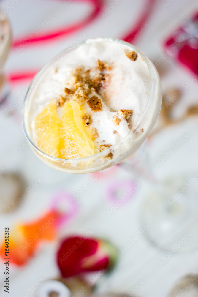 Ice cream dessert on table with hearts, ribbons and cloves. Ice cream dessert on table with hearts, ribbons and cloves.