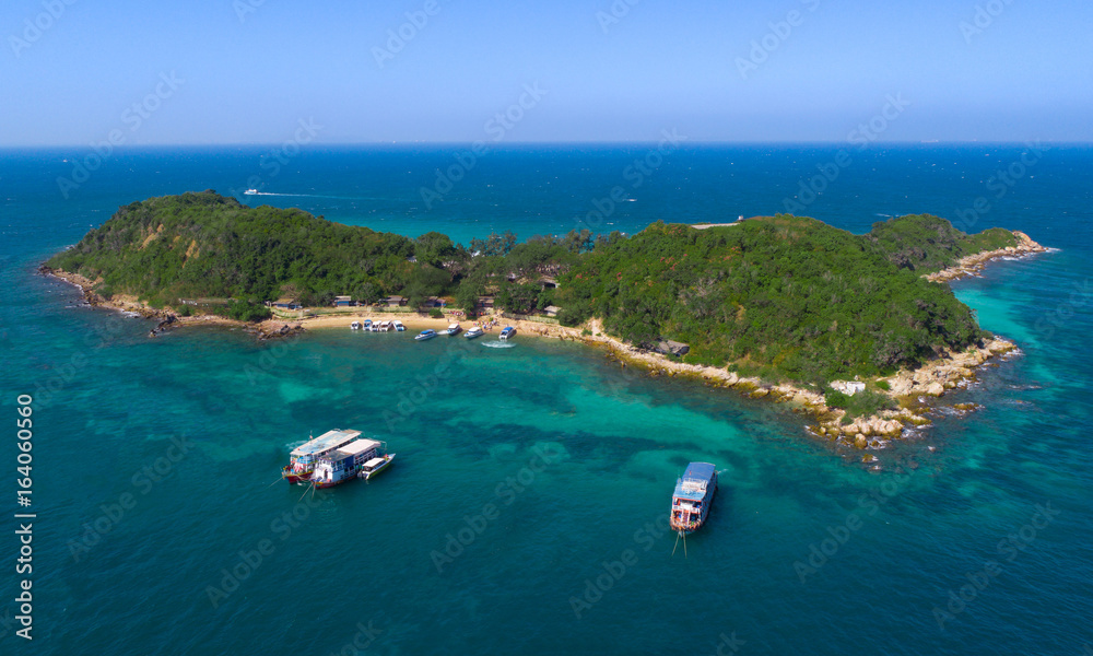 Fototapeta premium At Sea Island.Aerial view. Top view.amazing nature background.The color of the water and beautifully bright.Azure beach with rocky mountains and clear water of Thailand ocean at sunny day.