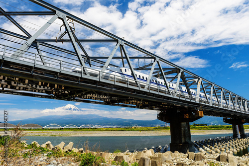 Shinkansen on railway bridge with Mt. Fuji