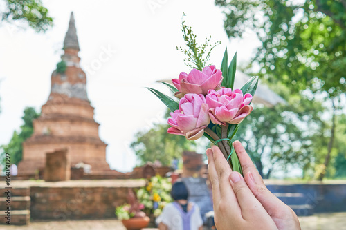 Close up Hand of woman that pay homage to Buddha image. This activity is shown to believing in a Buddha religion of people.
