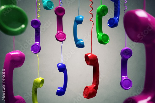 Red and multi-coloured telephone receiver hanging