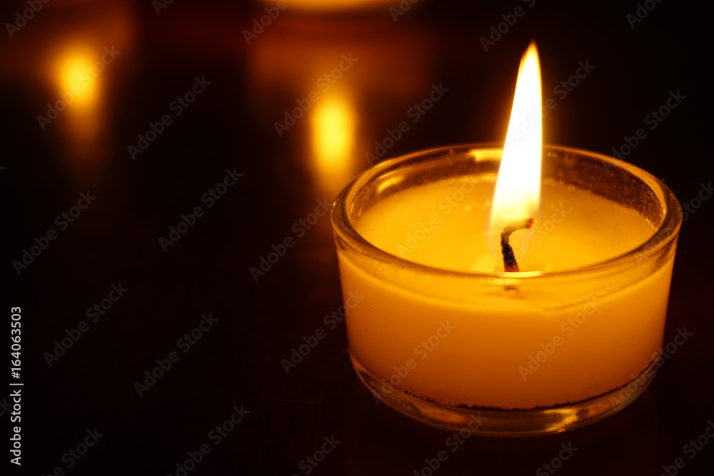 Candles light flame on low light background. Candles light flame on low light background.
