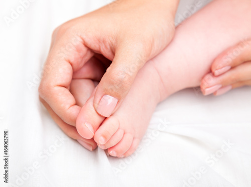 Little baby receiving osteopathic treatment of her foot