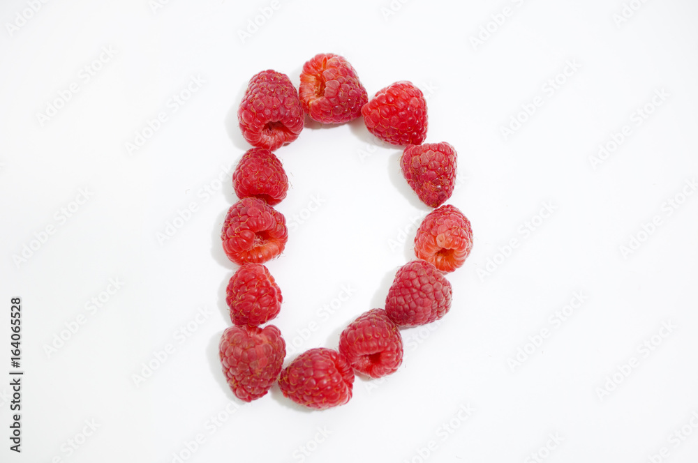 Alphabetical letter D made of raspberries on a white background