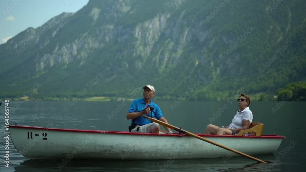 4k travel video, active senior couple sitting in rowboat on austrian mountain lake enjoying landscape and taking pictures
4k travel video, active senior couple sitting in rowboat on austrian mountain lake enjoying landscape and taking pictures