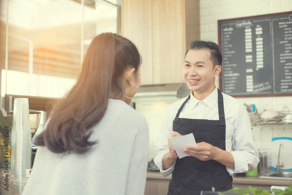 Asian barista man standing for taking order with attractive smiling at coffee shop. Man with owner business concept. 30-40 years old. Asian barista man standing for taking order with attractive smiling at coffee shop. Man with owner business concept. 30-40 years old.