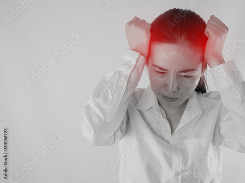 Young Asian woman touching head and having strong headache, concept of office worker health care lifestyle.