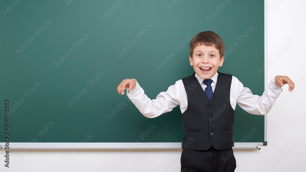 Pupil posing at school board, empty space, education concept Pupil posing at school board, empty space, education concept
