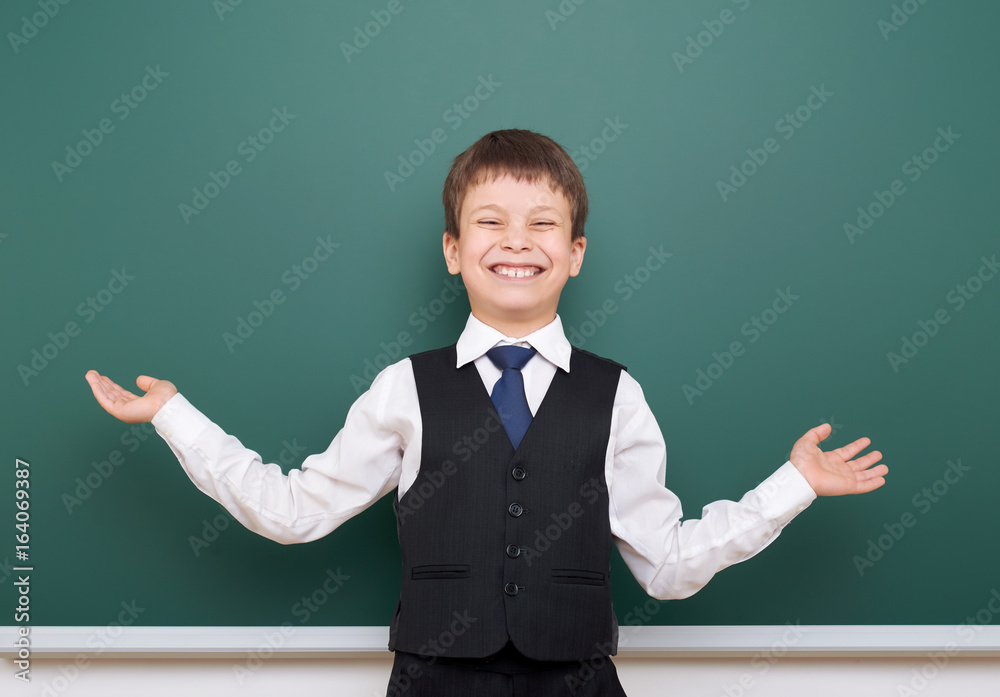 Pupil posing at school board, empty space, education concept Pupil posing at school board, empty space, education concept