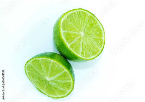 Sliced ripe juicy lime on white