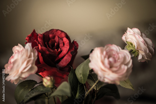 Bouquet of pink and red fabric roses, soft and romantic vintage filter, looking like an old painting, flowers still life