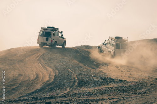 Cars driving in dusty desert © Volodymyr