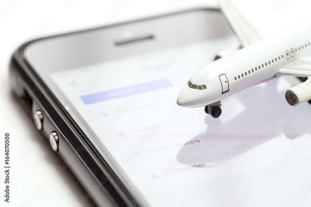 Booking or buying ticket air online and view flights per airline over the internet by mobile phone or smartphone for vacation travel journey trip Booking or buying ticket air online and view flights per airline over the internet by mobile phone or smartphone for vacation travel journey trip