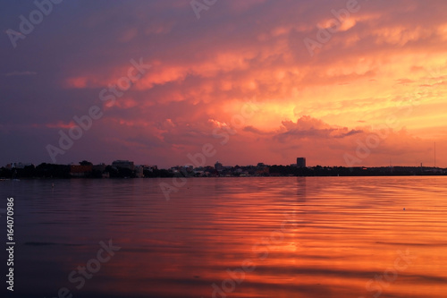 Amazing sunset over the lake.Landscape with a beautiful dramatic sunset sky after evening storm reflects in lake Mendota in the city of Madison Tenney Park,Wisconsin,USA.Long exposure horizontal shot.