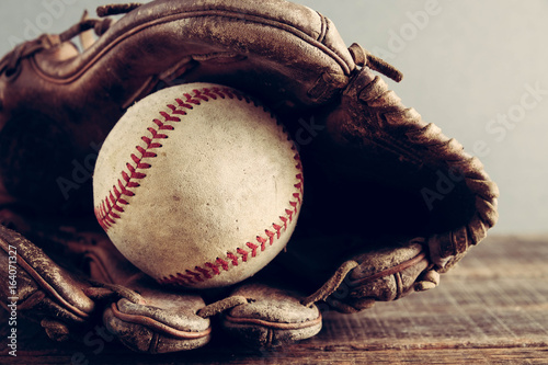 old Baseball and glove on wood background with filter effect retro vintage style