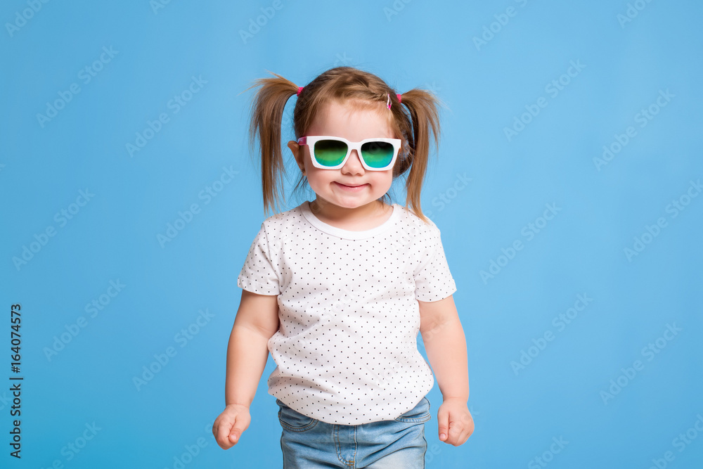 Fashion portrait of girl child on a blue background