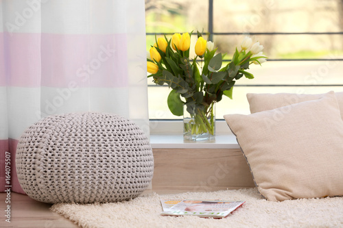 Vase with beautiful tulips on windowsill