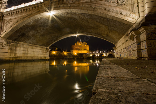 Castel sant'angelo with bridge shot at night from beneath the next bridge © Florian