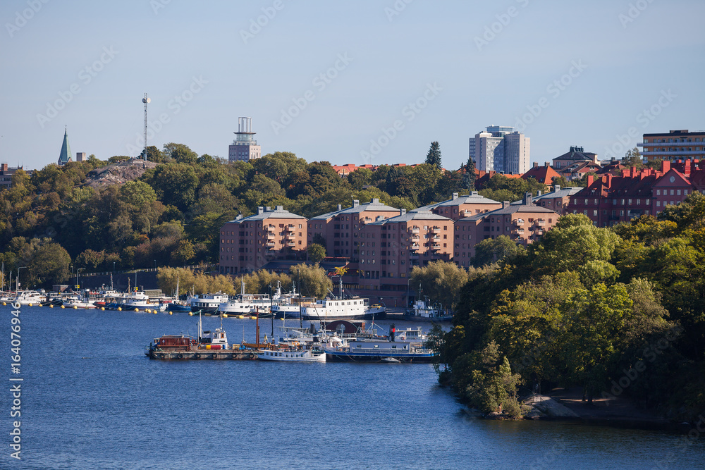 Naklejka premium Small private boats along canal in Stockholm. View from the bridge