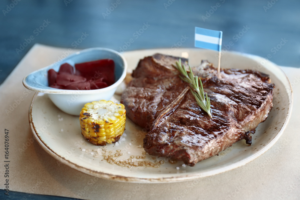 Composition with tasty beefsteak and vegetables on plate Composition with tasty beefsteak and vegetables on plate