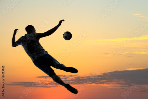 Soccer player with ball outdoors