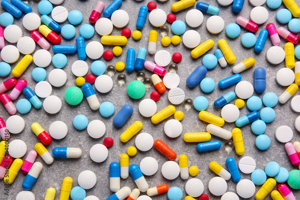 Different pills on grey background Different pills on grey background