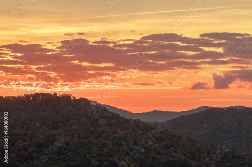 orange moorig sky at daybreak over the rolling hills and mountains of the North Carolina Appalachians in the fall © makasana photo