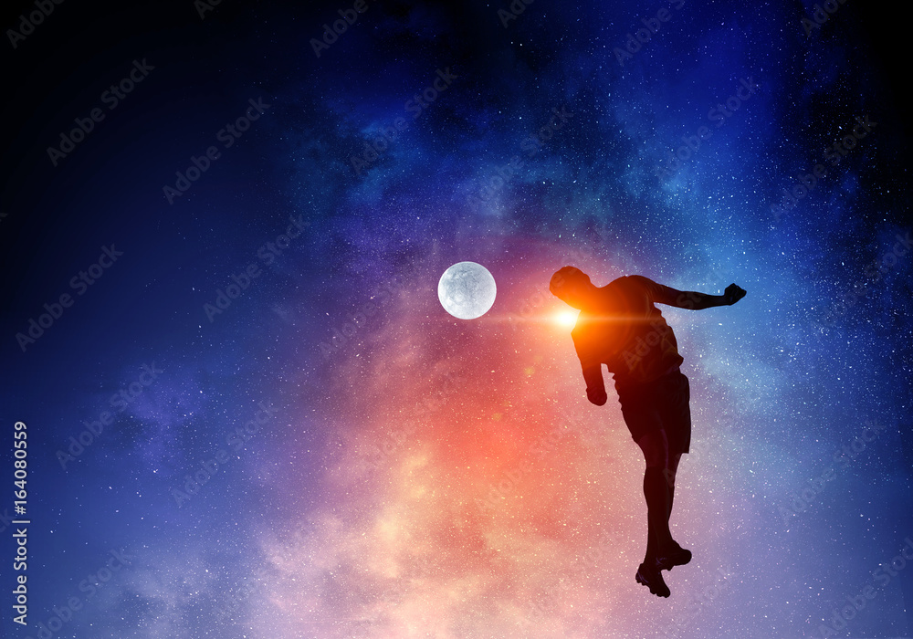 Naklejka premium Soccer player with ball outdoors