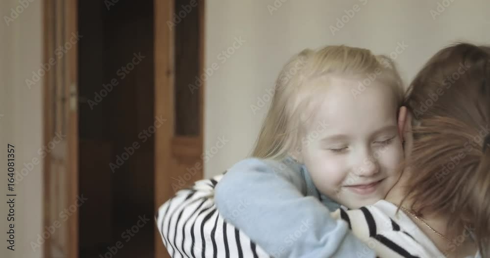 Blonde girl hugging a young woman. Blonde girl hugging a young woman.